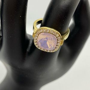 Gold colored ring with cut pink and white gems